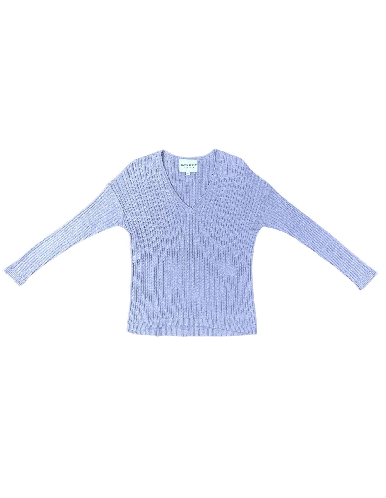 A lavender v-neck sweater over a white background